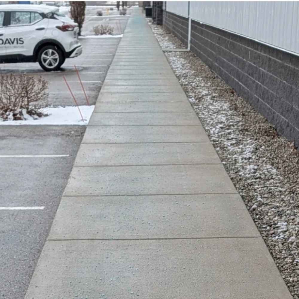 Snow shoveling service clearing residential driveway and walkway